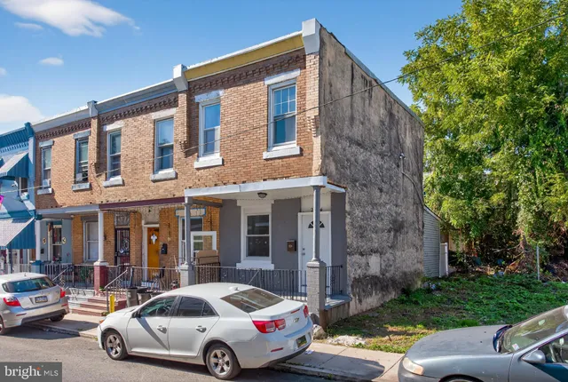a car parked in front of a brick house