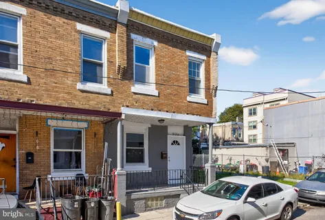 a front view of a building with parking