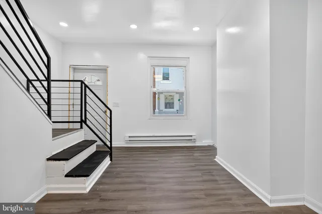 a view of an entryway with wooden floor