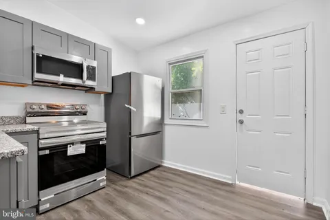 a kitchen with a refrigerator stove and microwave