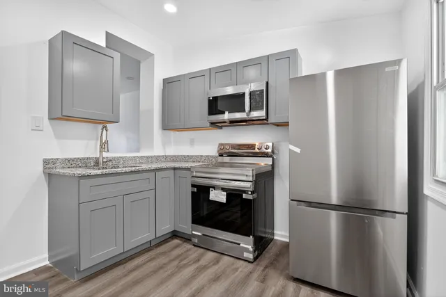 a kitchen with stainless steel appliances a refrigerator sink and microwave