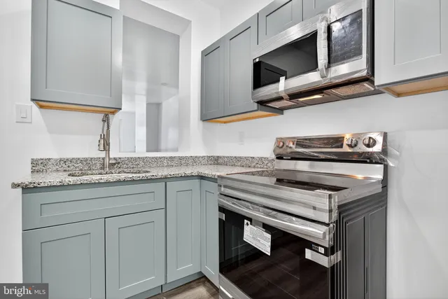 a kitchen with cabinets appliances and a sink