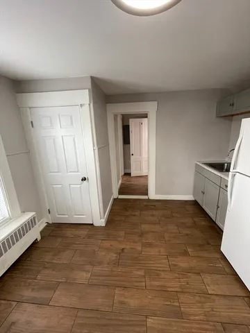 a view of an empty room and wooden floor