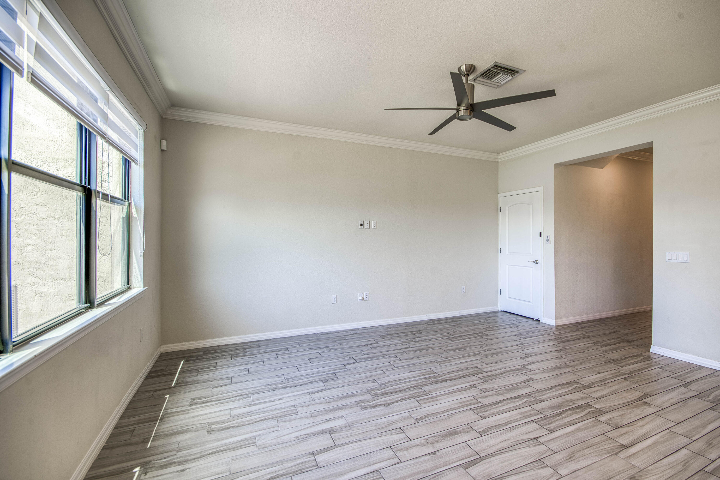 8301 Rearing Lane Lake Worth, FL 33467 - Photo 8 of 33 wooden floor in an empty room with a window