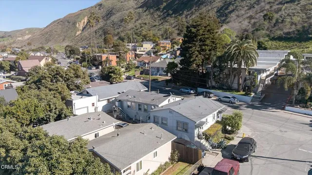 an aerial view of a house with a yard
