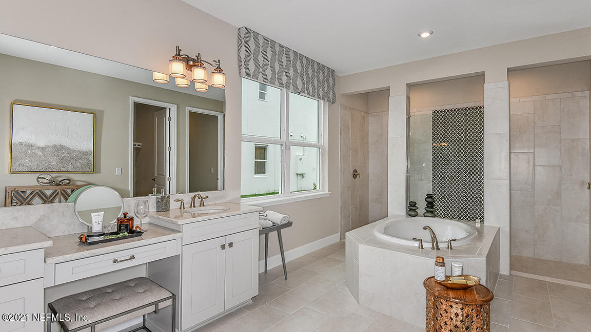 518 Marquesa Circle St. Johns, FL 32259 - Photo 12 of 27 a spacious bathroom with a granite countertop sink mirror and bathtub