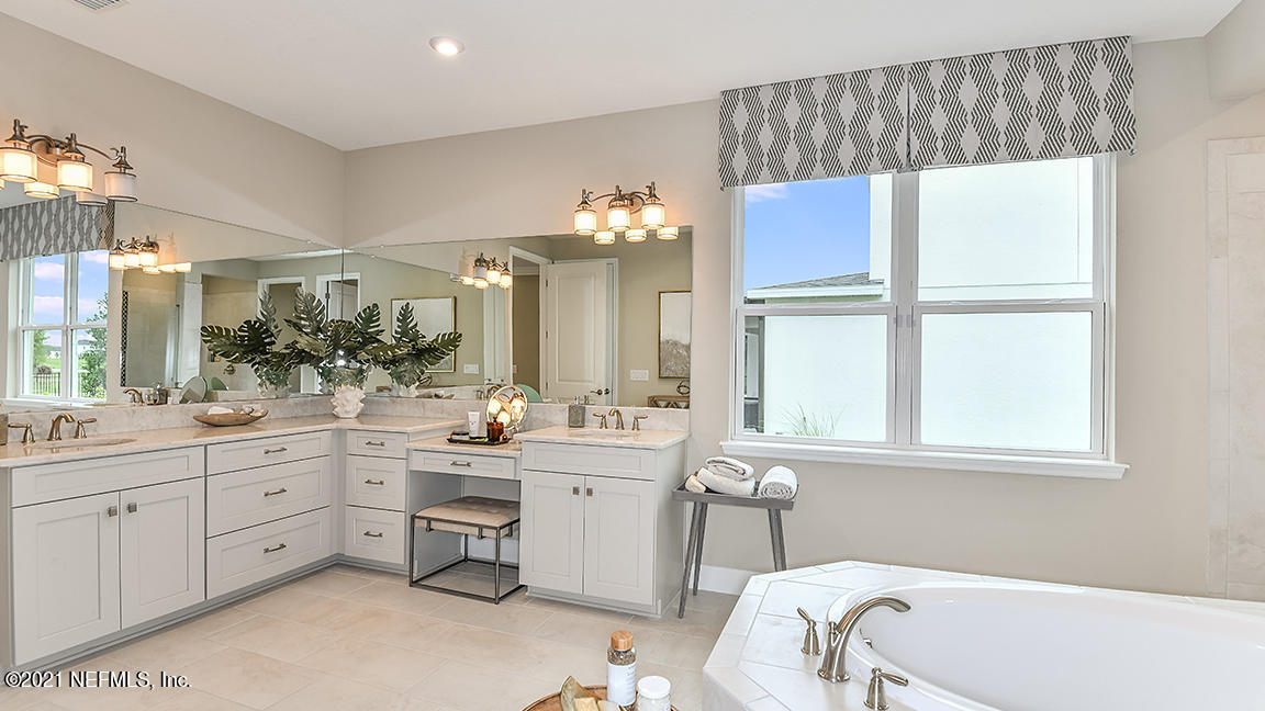 518 Marquesa Circle St. Johns, FL 32259 - Photo 14 of 27 a bathroom with a double vanity sink window and a mirror