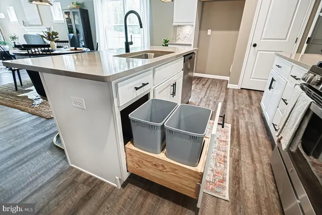 a kitchen with sink stove and refrigerator