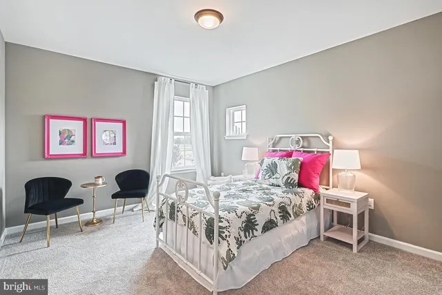 a bedroom with a bed and a chair