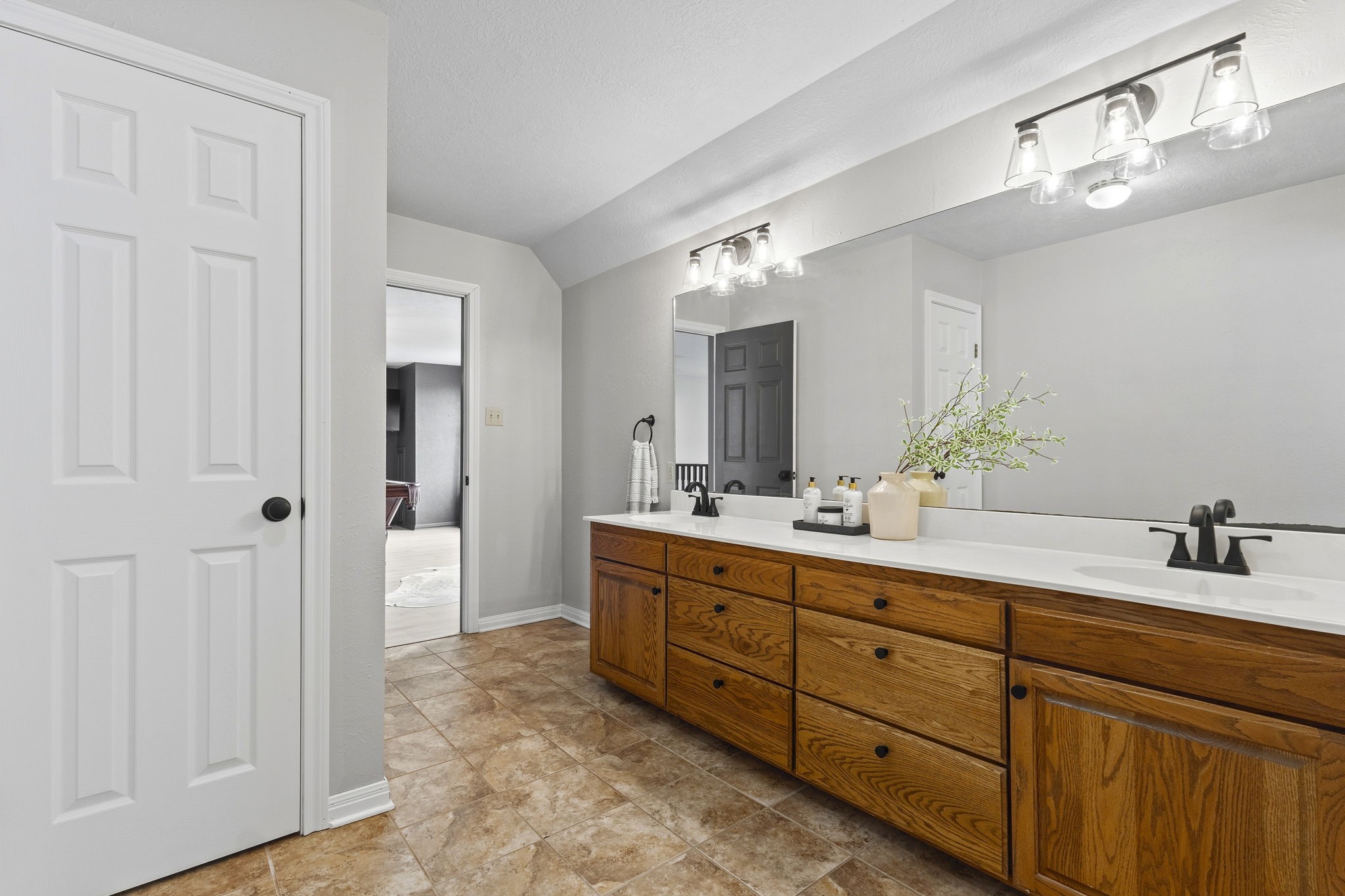 16421 Westbury Road Beaumont, TX 77713 - Photo 20 of 29 a bathroom with a double vanity sink and a mirror