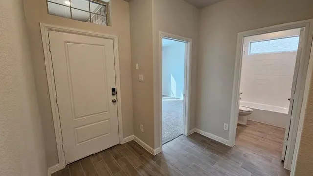 a view of a backyard with a small cabin and wooden fence