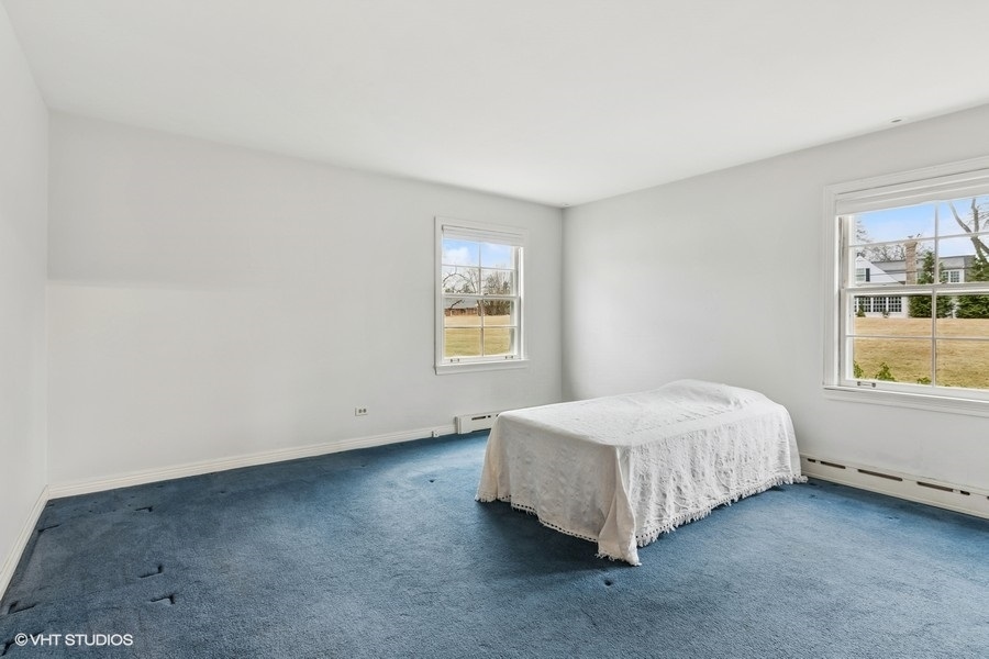 725 Milton Road Inverness, IL 60067 - Photo 11 of 24 a bed sitting in a bedroom next to a window