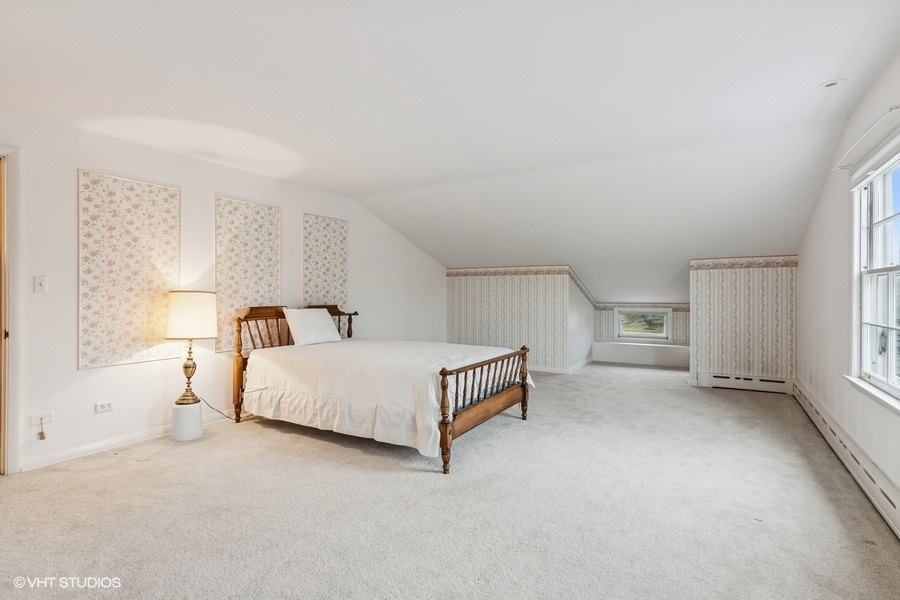 725 Milton Road Inverness, IL 60067 - Photo 17 of 24 a spacious bedroom with a bed and a window