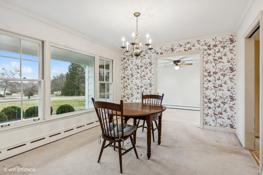 725 Milton Road Inverness, IL 60067 - Photo 4 of 24 a view of a dining room with furniture window and outside view