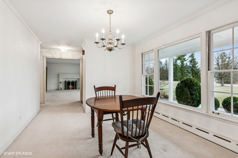 725 Milton Road Inverness, IL 60067 - Photo 5 of 24 a view of a dining room with furniture window and outside view