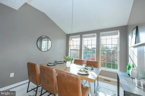 a view of a dining room with furniture wooden floor and a chandelier