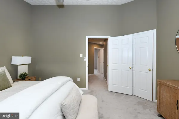 a bedroom with a bed and a lamp