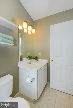a bathroom with a sink a toilet and mirror