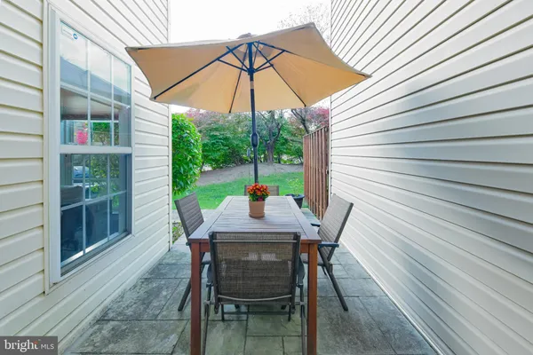 a table and chairs in patio of the house