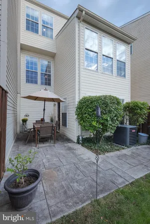 a view of a backyard with plants and a patio