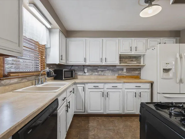 a kitchen with a sink stove and cabinets