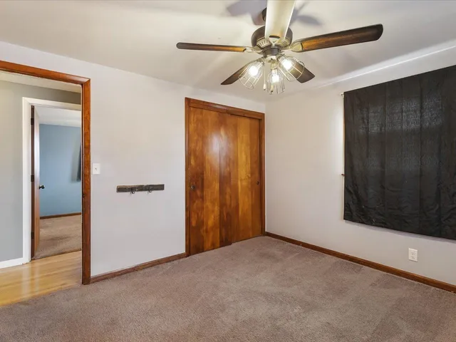 a view of an empty room with a ceiling fan