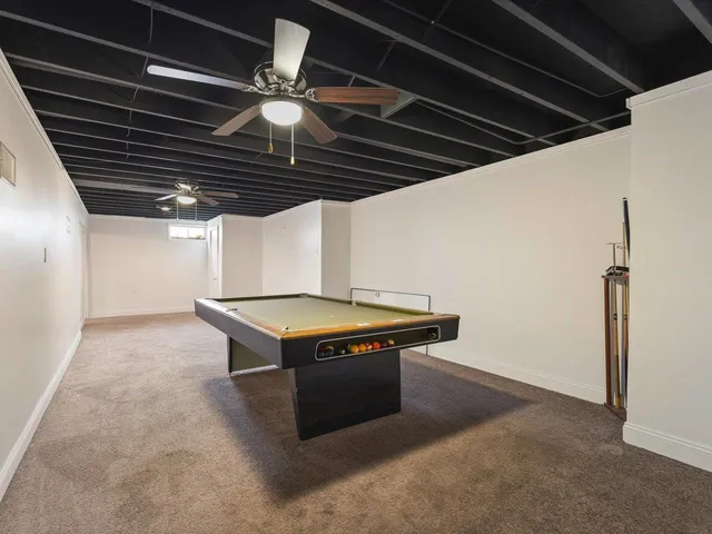 an empty room with a ceiling fan and a window