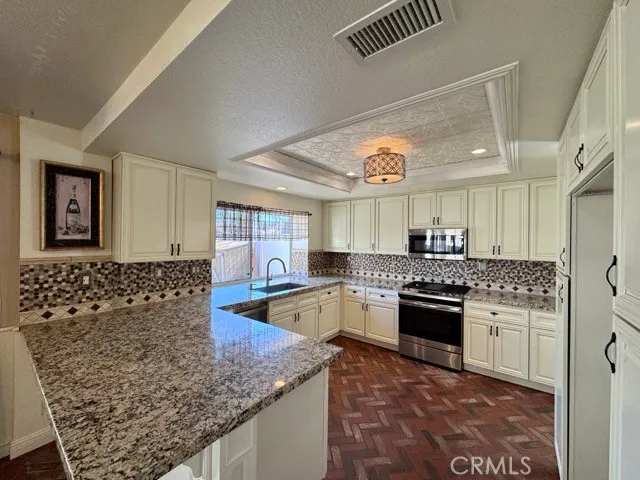 a view of a kitchen with a sink and cabinets