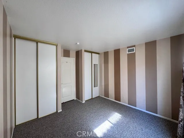 a view of staircase with railing and a chandelier