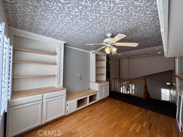 an empty room with closet and a ceiling fan