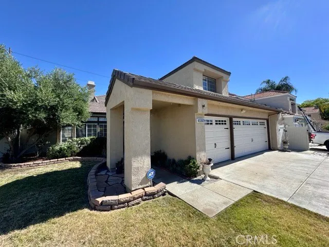 a view of a porch with furniture and garden
