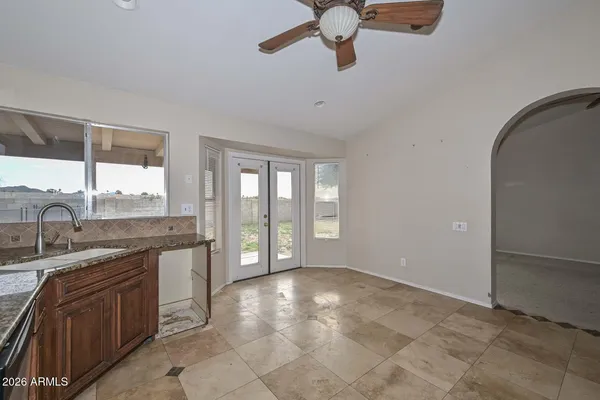 a kitchen with granite countertop a stove microwave and refrigerator