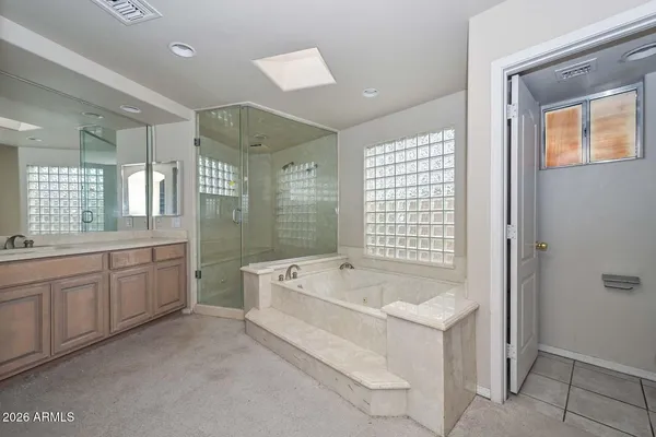 a spacious bathroom with a double vanity sink and a mirror