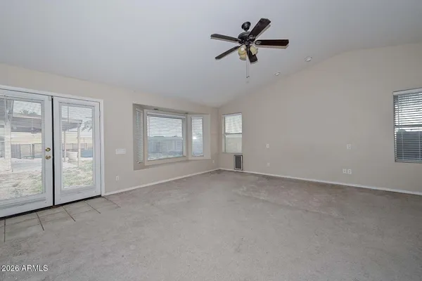 a view of a livingroom with a ceiling fan and window