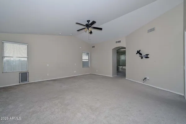 a view of a livingroom with a ceiling fan and window