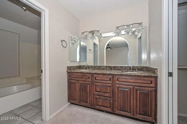 a large kitchen with stainless steel appliances granite countertop a stove a sink and a refrigerator