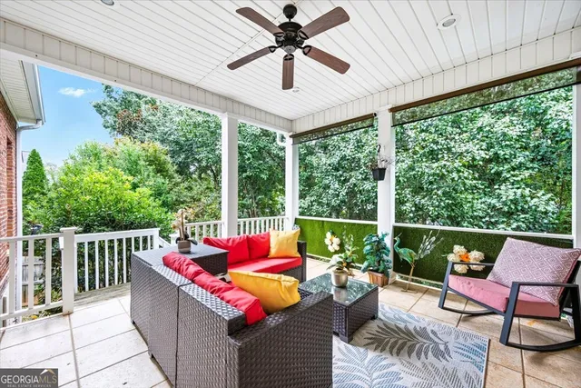 a balcony with furniture and a potted plant