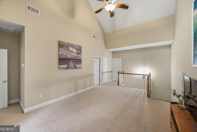 a view of a livingroom with a chandelier fan
