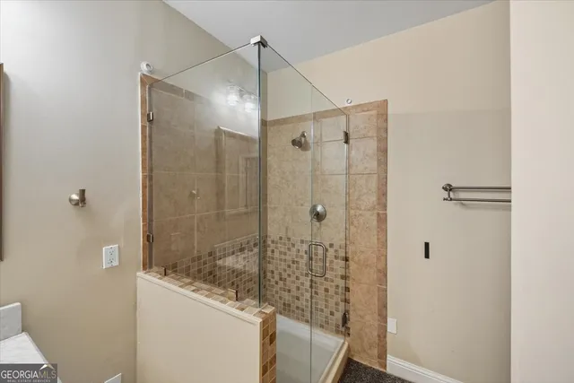 a bathroom with a shower and a sink