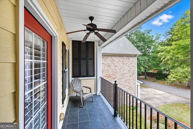 a view of a porch with wooden floor and outdoor seating