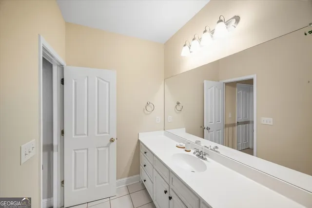 a spacious bathroom with a double vanity sink and a mirror