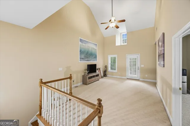 a view of a livingroom with wooden floor and staircase