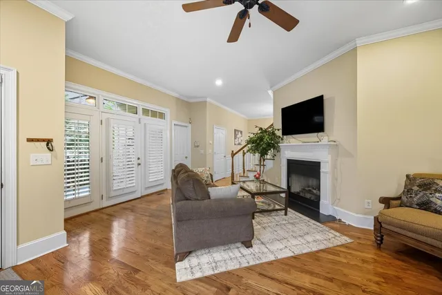a living room with furniture a fireplace and a flat screen tv