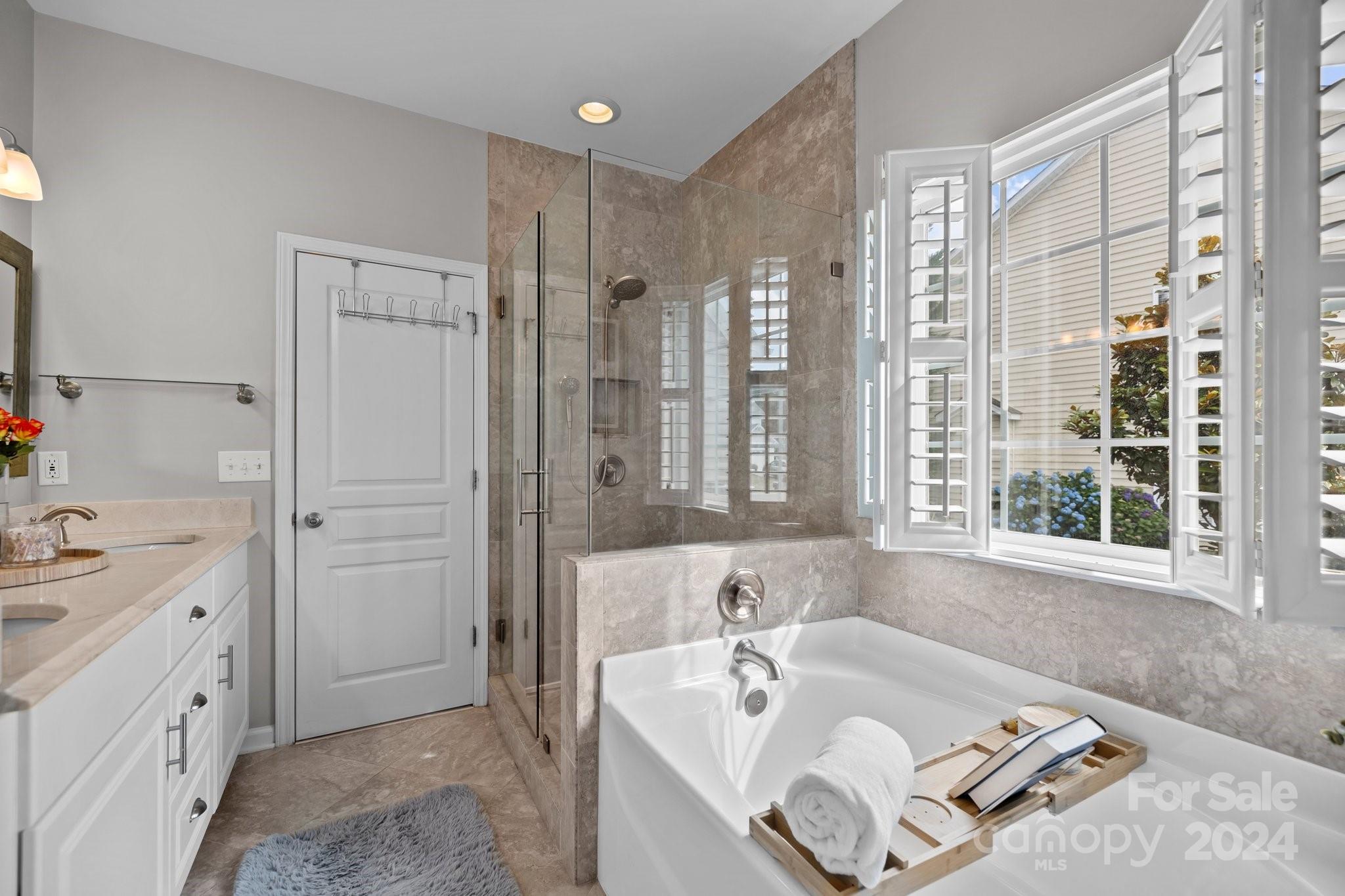 449 Silver Cypress Lane Fort Mill, SC 29708 - Photo 19 of 42 a bathroom with a tub sink and a window