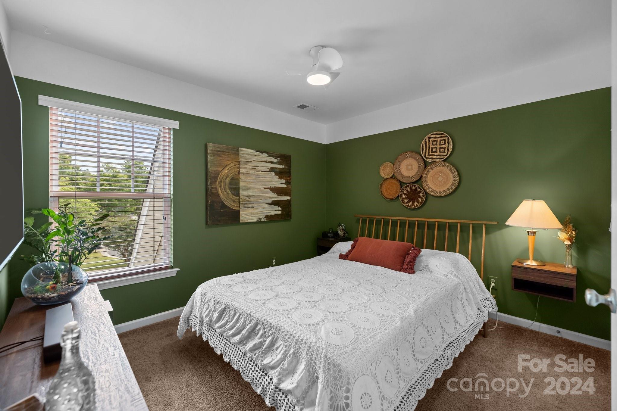 449 Silver Cypress Lane Fort Mill, SC 29708 - Photo 27 of 42 a bedroom with a bed and a chandelier