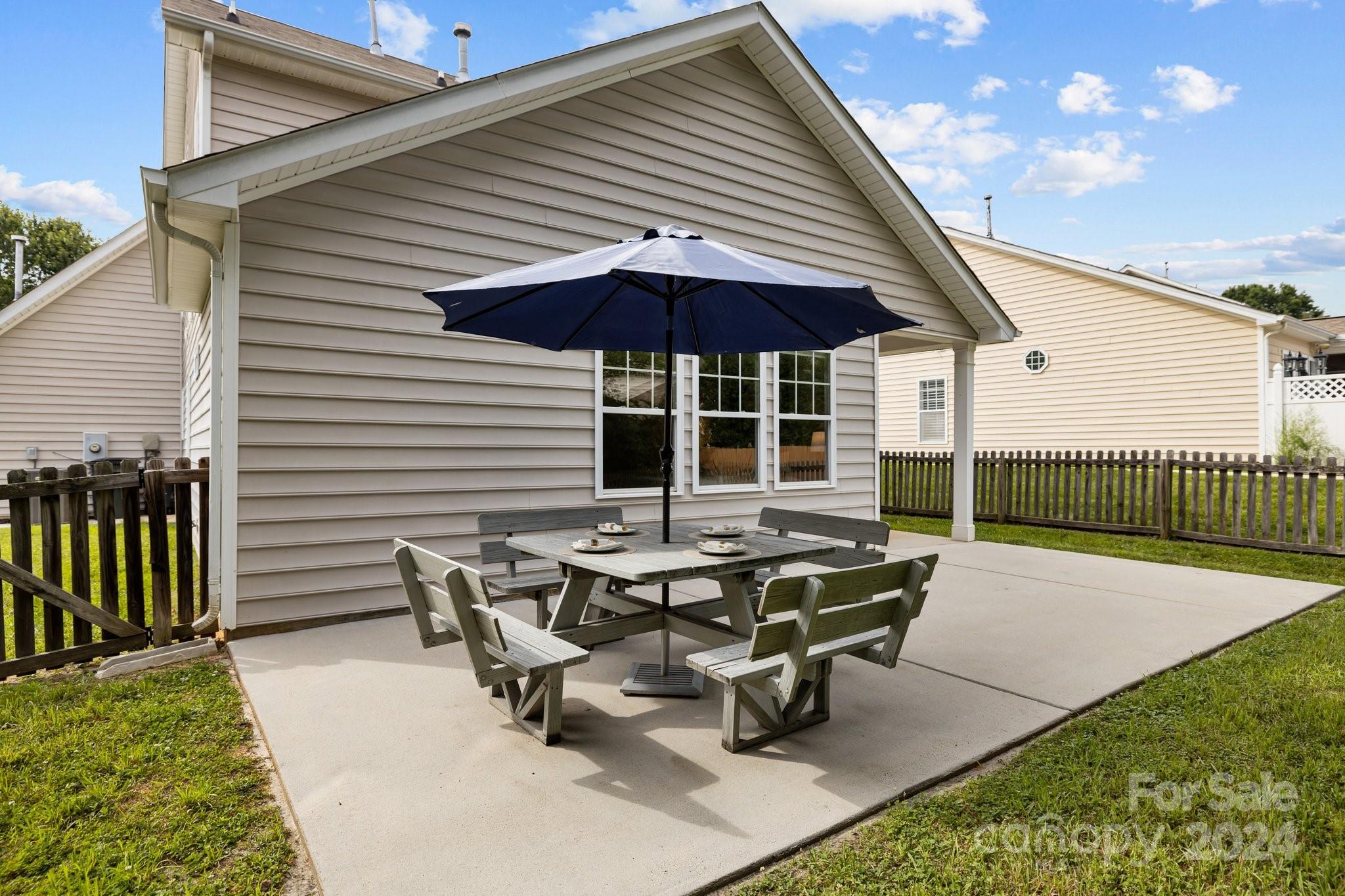 449 Silver Cypress Lane Fort Mill, SC 29708 - Photo 34 of 42 a roof deck with table and chairs under an umbrella