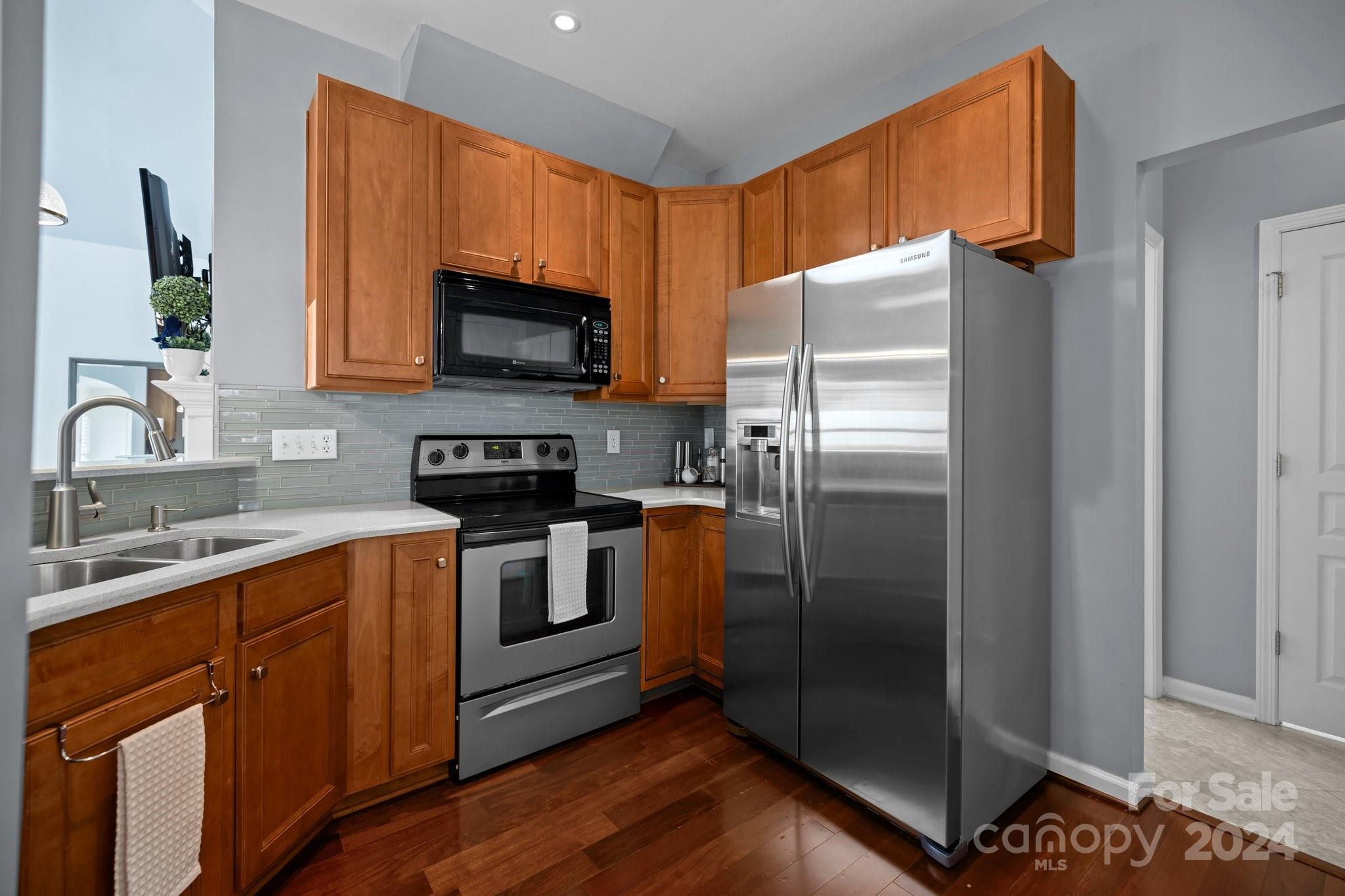 449 Silver Cypress Lane Fort Mill, SC 29708 - Photo 10 of 42 a kitchen with stainless steel appliances granite countertop a refrigerator stove and microwave