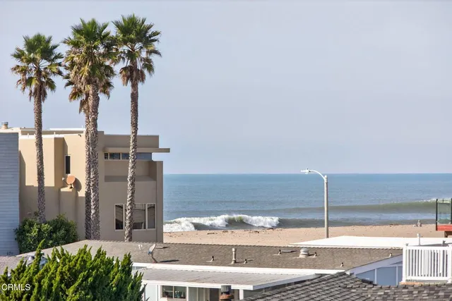 a spacious bedroom with a bed and a chandelier