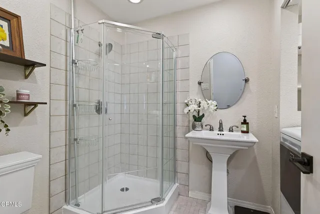 a view of a living room with furniture and a kitchen