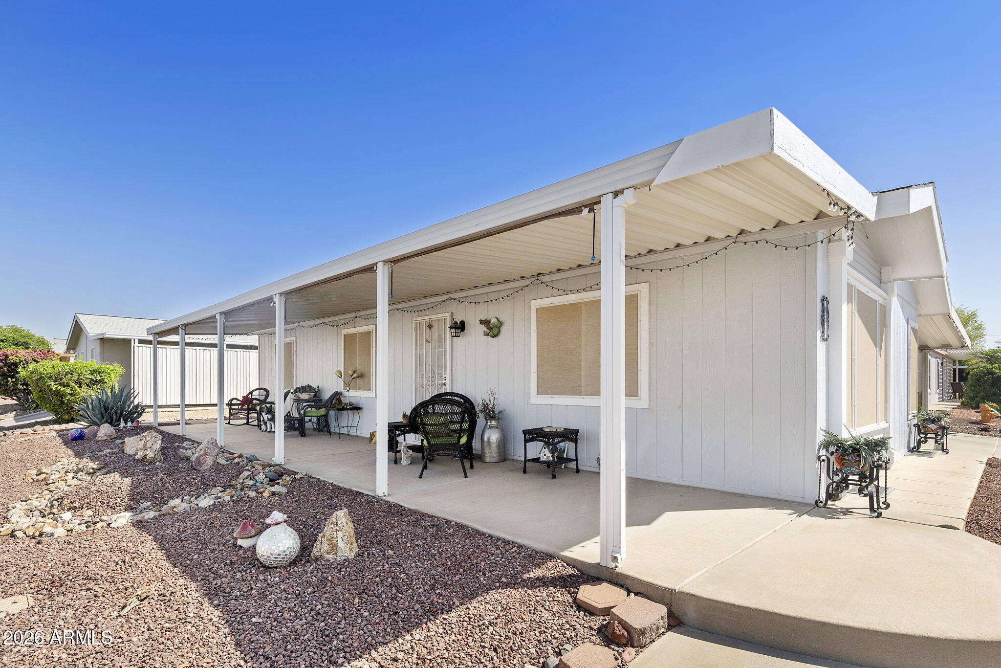 a view of a patio with couches chairs and potted plants